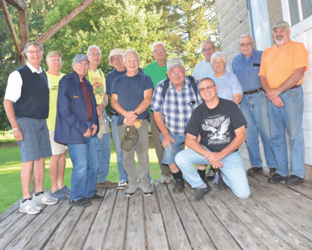 a group of Lions Club members on a deck outdoors